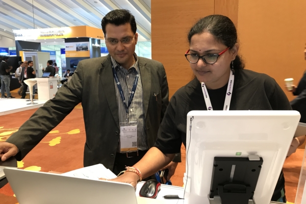 Shravani, Software Engineer, presenting to customer at FORCS booth